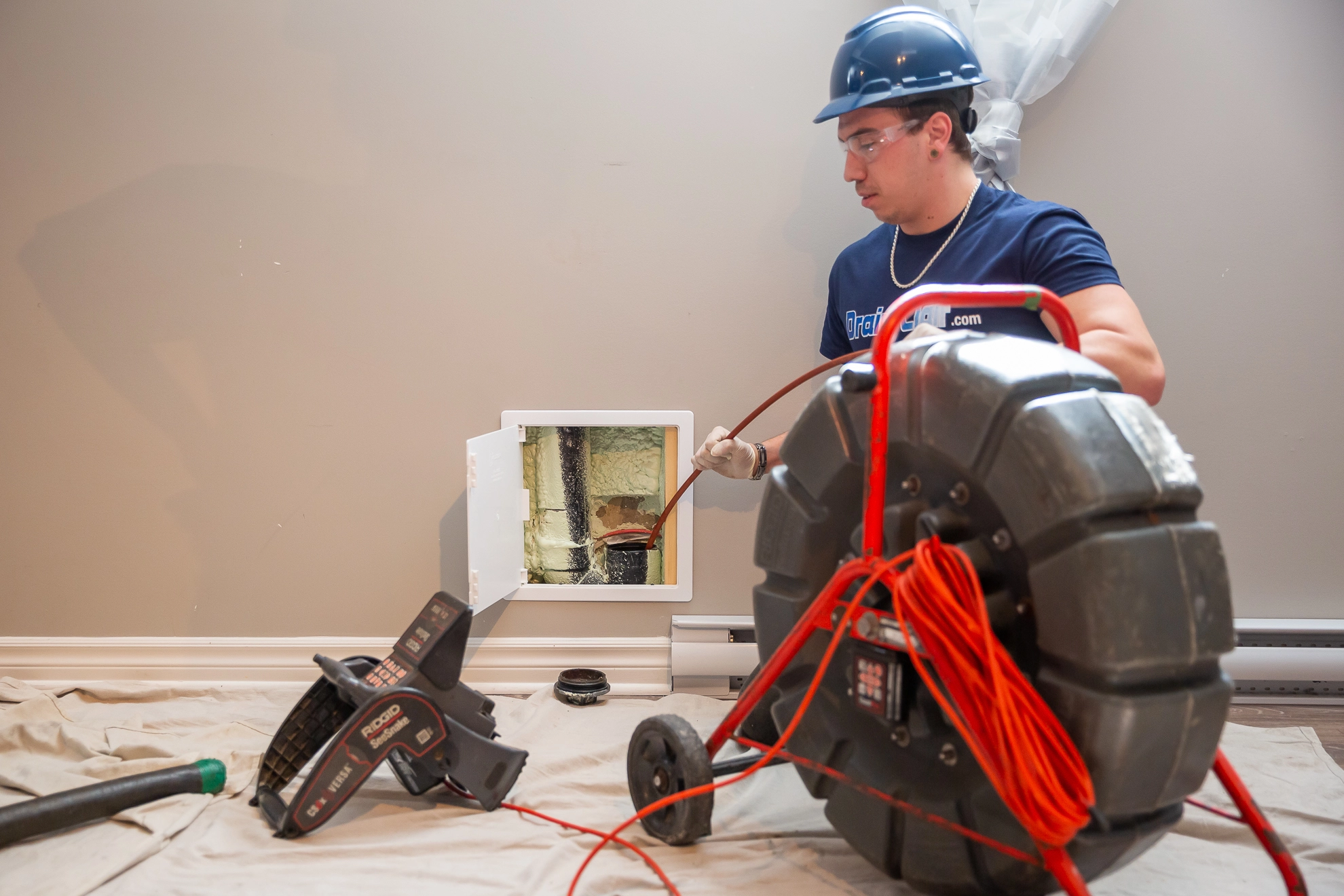 Drain cleaning professional performing a sewer and drain inspection